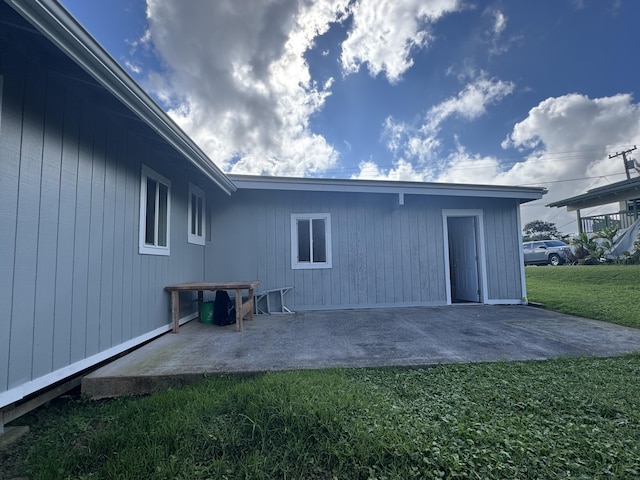 back of house with a yard and a patio area