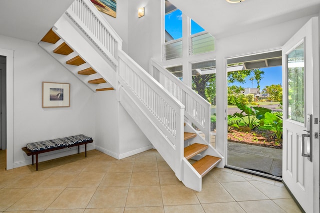 staircase with tile patterned flooring and baseboards