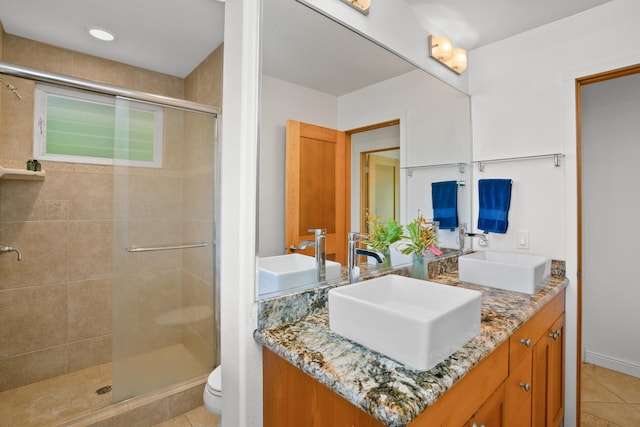 bathroom featuring a sink, toilet, and double vanity