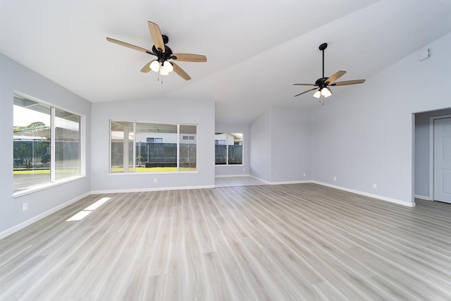 unfurnished living room with ceiling fan, vaulted ceiling, and light wood-type flooring