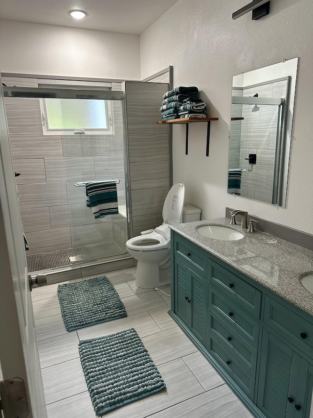 bathroom featuring toilet, vanity, and an enclosed shower