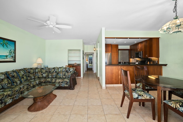 tiled living room featuring ceiling fan and sink