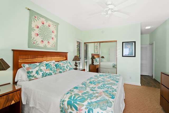 carpeted bedroom featuring ceiling fan and a closet