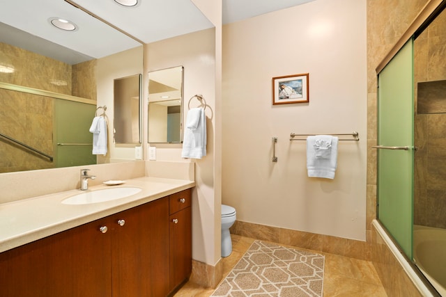 full bathroom featuring enclosed tub / shower combo, toilet, vanity, and tile patterned flooring