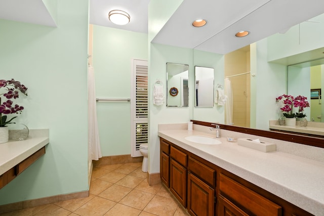 bathroom featuring toilet, walk in shower, tile patterned floors, and vanity