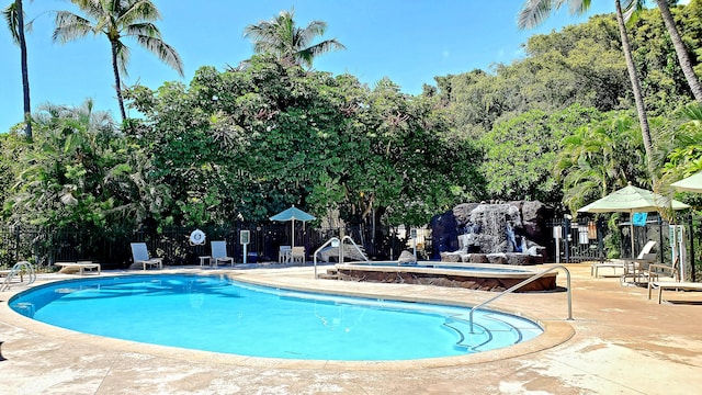 view of pool featuring a hot tub and a patio