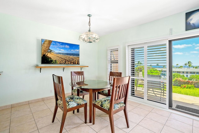 dining room with a notable chandelier and light tile patterned flooring