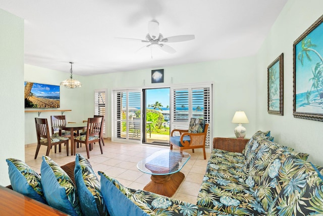 tiled living room featuring ceiling fan with notable chandelier