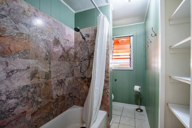 bathroom featuring toilet, tile patterned flooring, shower / tub combo, and wood walls