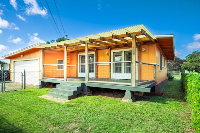 view of front of house featuring a garage and a front lawn