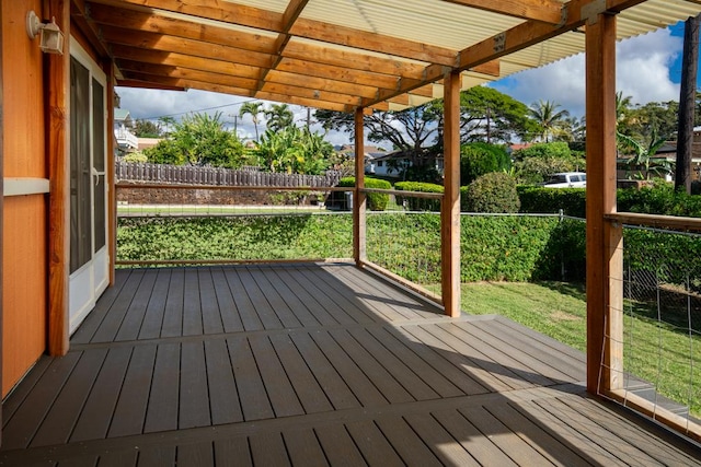 wooden deck with a pergola and a lawn