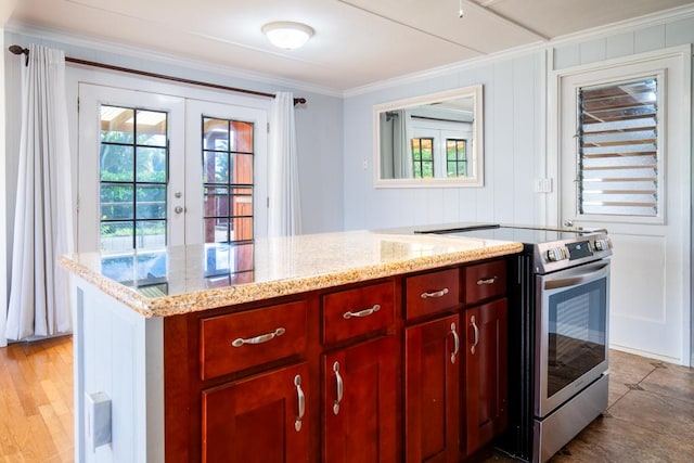 kitchen with light stone countertops, french doors, electric range, and ornamental molding