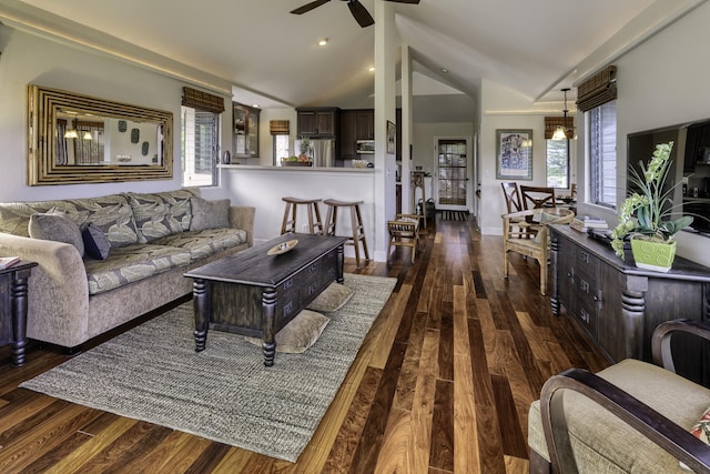 living room featuring dark wood-type flooring, vaulted ceiling, and ceiling fan