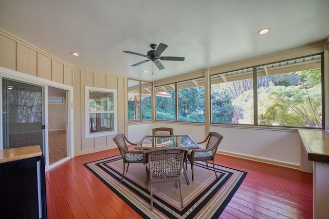 sunroom featuring ceiling fan