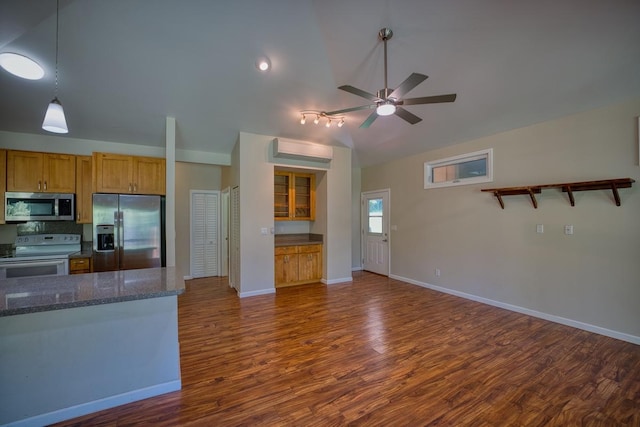 kitchen featuring pendant lighting, ceiling fan, stainless steel appliances, dark hardwood / wood-style floors, and dark stone counters