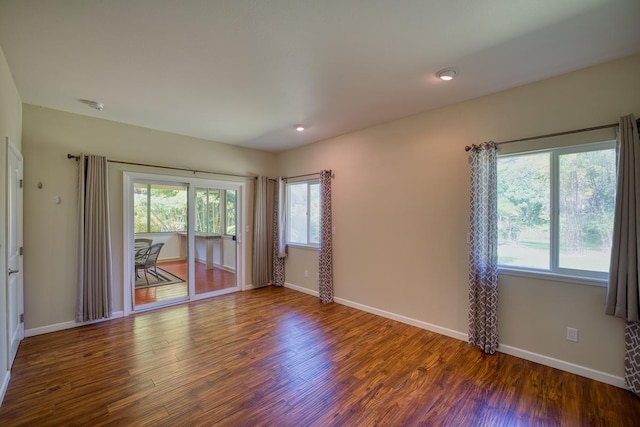 unfurnished room with dark hardwood / wood-style floors