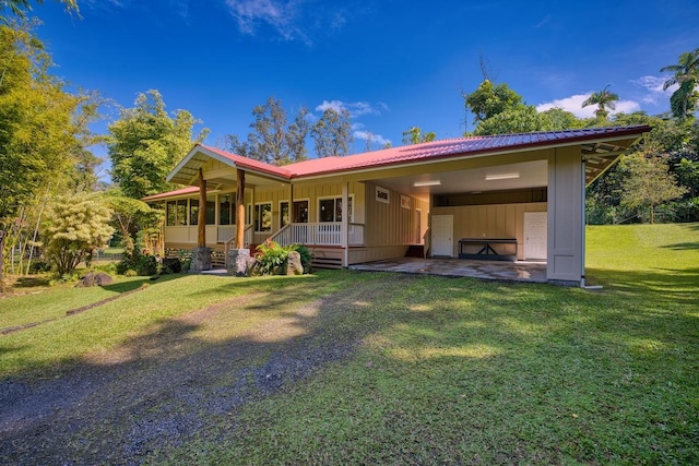 rear view of property with a yard