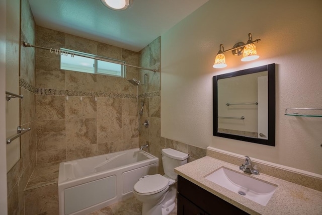 full bathroom with vanity, toilet, and tiled shower / bath