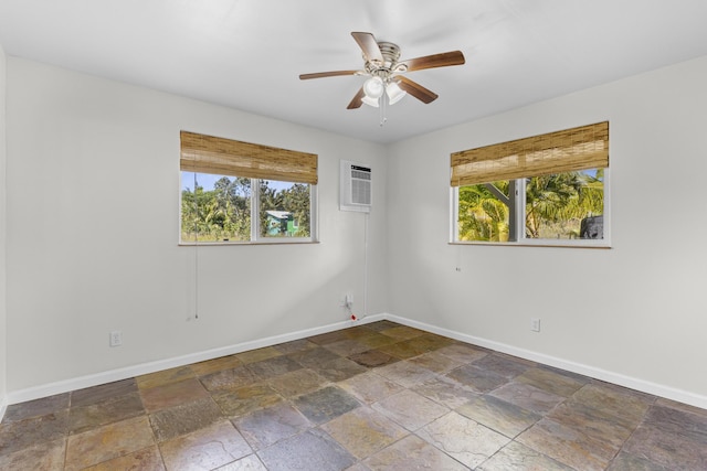 unfurnished room featuring plenty of natural light, a wall mounted air conditioner, and ceiling fan