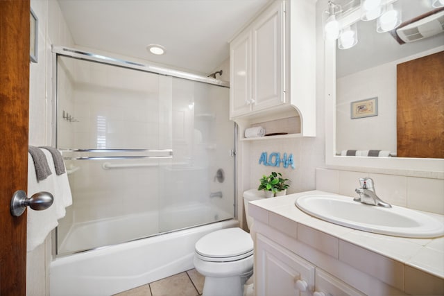 full bathroom featuring toilet, decorative backsplash, bath / shower combo with glass door, tile patterned flooring, and vanity