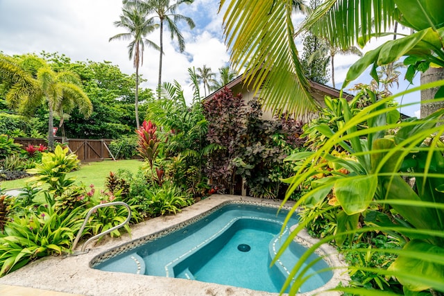 view of swimming pool featuring a yard