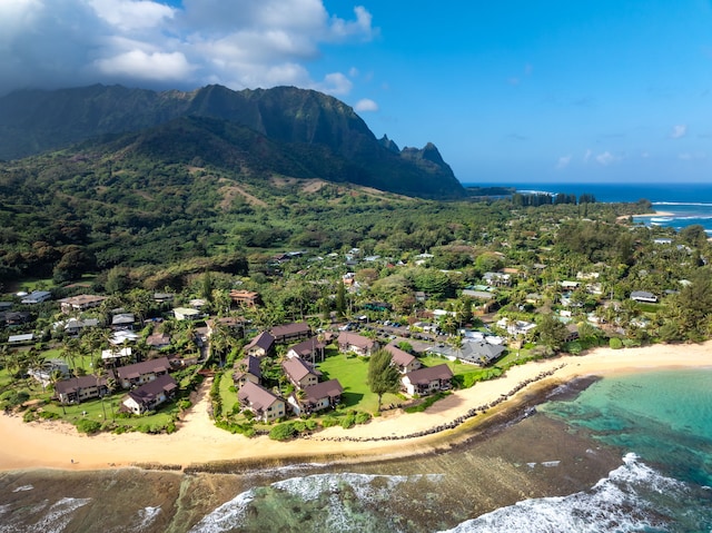 aerial view featuring a water and mountain view and a view of the beach