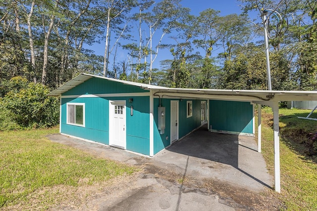 garage with a carport and a yard