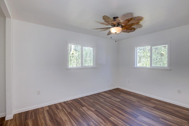 empty room with dark hardwood / wood-style floors and ceiling fan