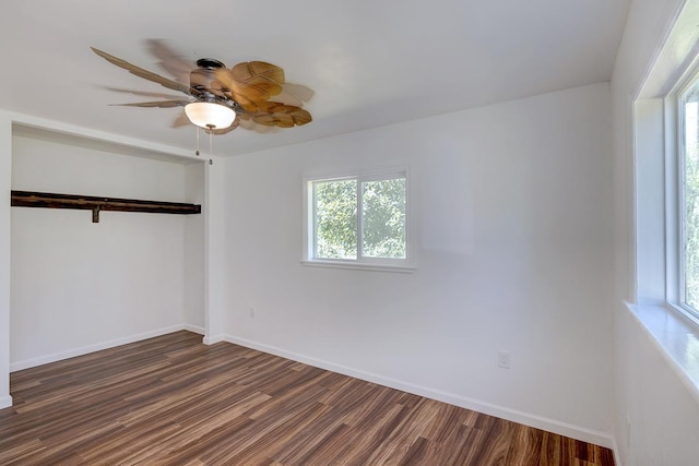 empty room with dark wood-type flooring and ceiling fan