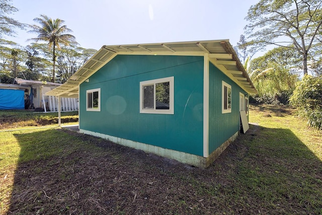 view of side of home with a lawn