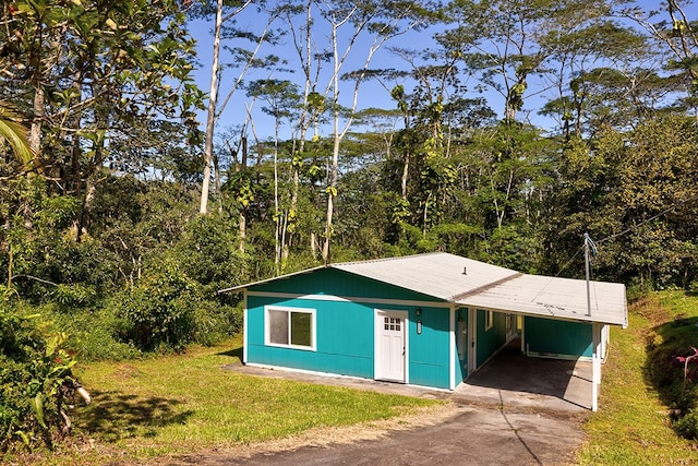 exterior space featuring a yard and a carport