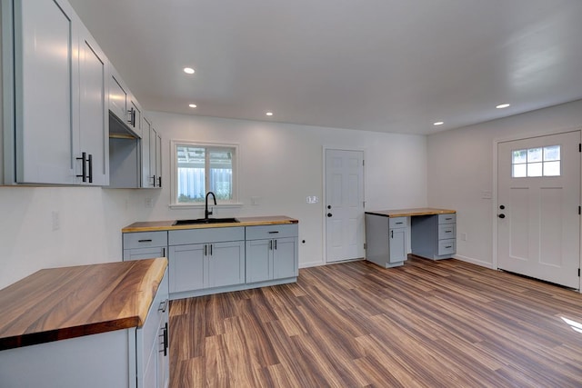 kitchen featuring a healthy amount of sunlight, sink, and wood counters