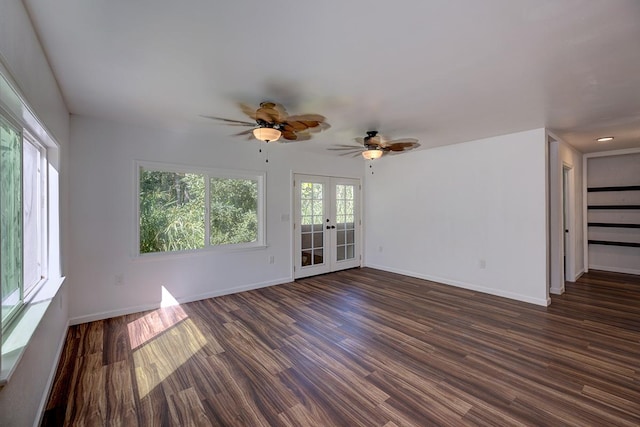 unfurnished living room featuring a healthy amount of sunlight, dark wood-type flooring, ceiling fan, and french doors