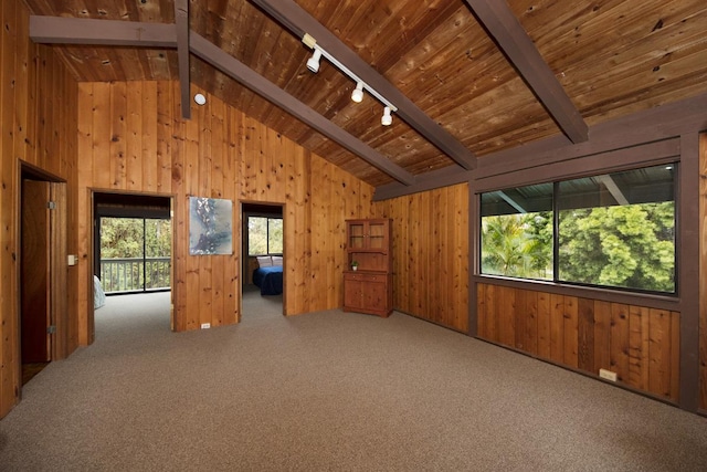 carpeted spare room featuring beamed ceiling, rail lighting, high vaulted ceiling, and wood ceiling