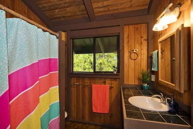 bathroom featuring wood ceiling, sink, and beam ceiling