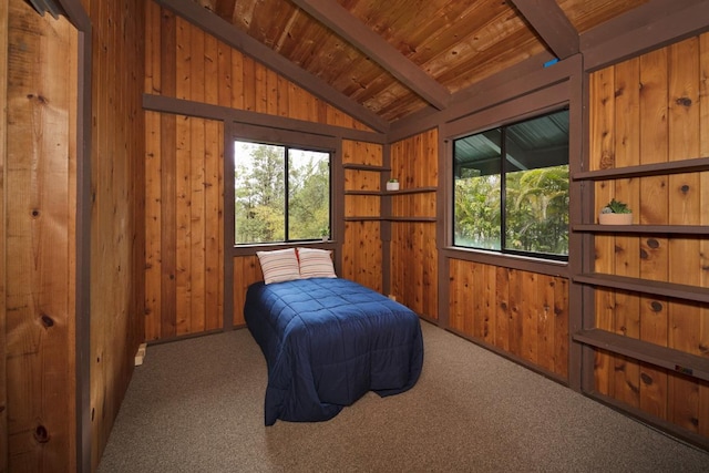 carpeted bedroom with lofted ceiling with beams, wooden ceiling, and wood walls