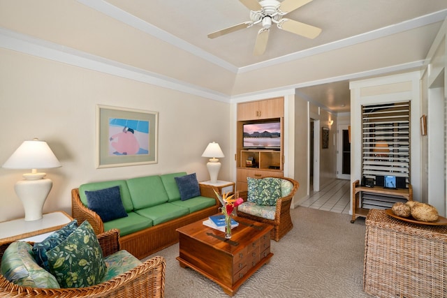 carpeted living room featuring ceiling fan and ornamental molding