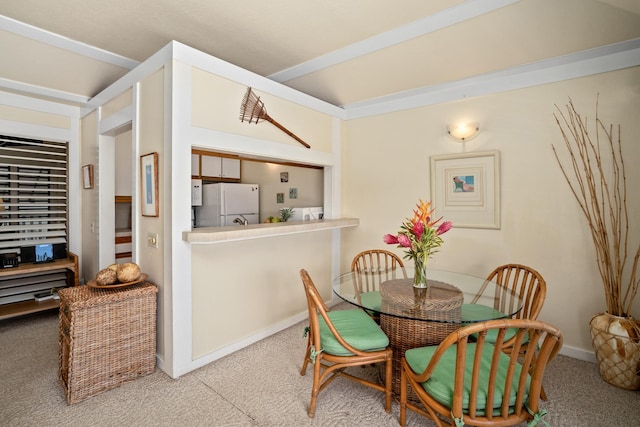 dining area featuring light carpet and lofted ceiling