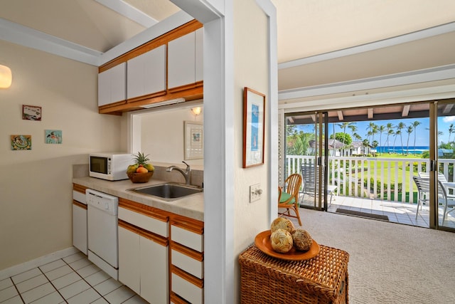 kitchen with light carpet, sink, white appliances, and white cabinetry