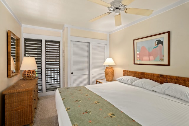 carpeted bedroom with ceiling fan and a closet