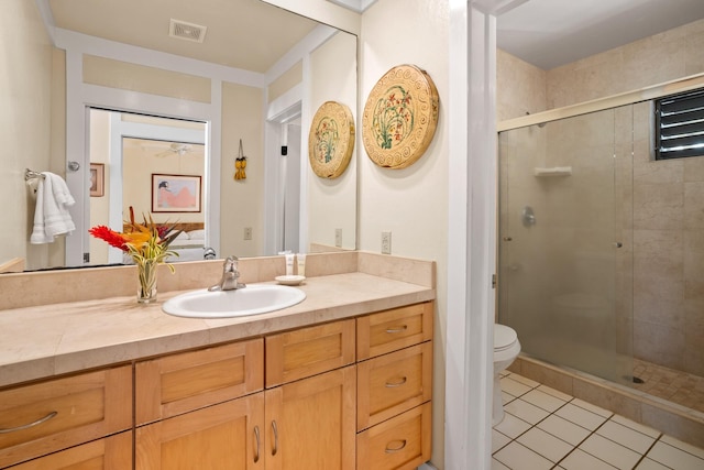 bathroom with toilet, walk in shower, tile patterned floors, and vanity