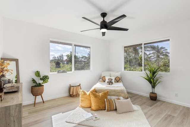 living area featuring ceiling fan, a healthy amount of sunlight, and light hardwood / wood-style flooring