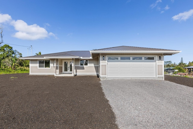 view of front of property with a garage and french doors