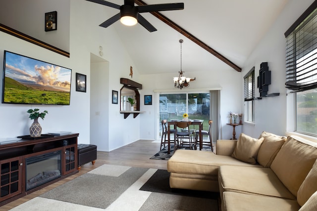 living room with hardwood / wood-style flooring, high vaulted ceiling, beam ceiling, and ceiling fan with notable chandelier