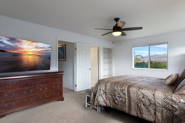 bedroom featuring light carpet and ceiling fan