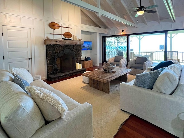 living room with wood-type flooring, beamed ceiling, ceiling fan, a fireplace, and high vaulted ceiling