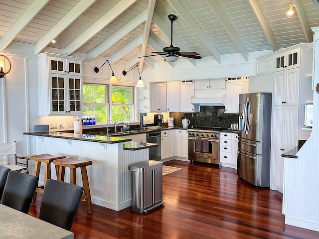 kitchen with sink, white cabinetry, decorative light fixtures, stainless steel appliances, and kitchen peninsula