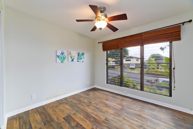 spare room with dark hardwood / wood-style floors and ceiling fan