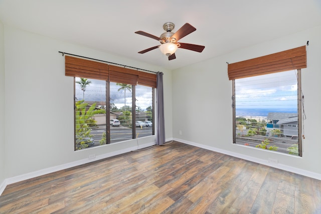 empty room with ceiling fan and wood-type flooring