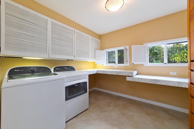 laundry room featuring cabinets and separate washer and dryer